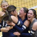 Soldotna's Rebekah Pieh (17) is mobbed by Cassidy Kruse, Teagen Kobylarz and Grayson Henry after a match-winning block Tuesday, Aug. 26, 2025, at Nikiski Middle-High School in Nikiski, Alaska. (Photo by Jeff Helminiak/Peninsula Clarion)
