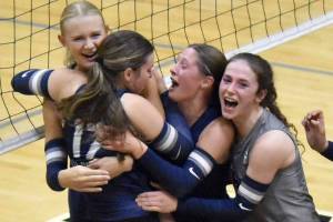 Soldotna's Rebekah Pieh (17) is mobbed by Cassidy Kruse, Teagen Kobylarz and Grayson Henry after a match-winning block Tuesday, Aug. 26, 2025, at Nikiski Middle-High School in Nikiski, Alaska. (Photo by Jeff Helminiak/Peninsula Clarion)