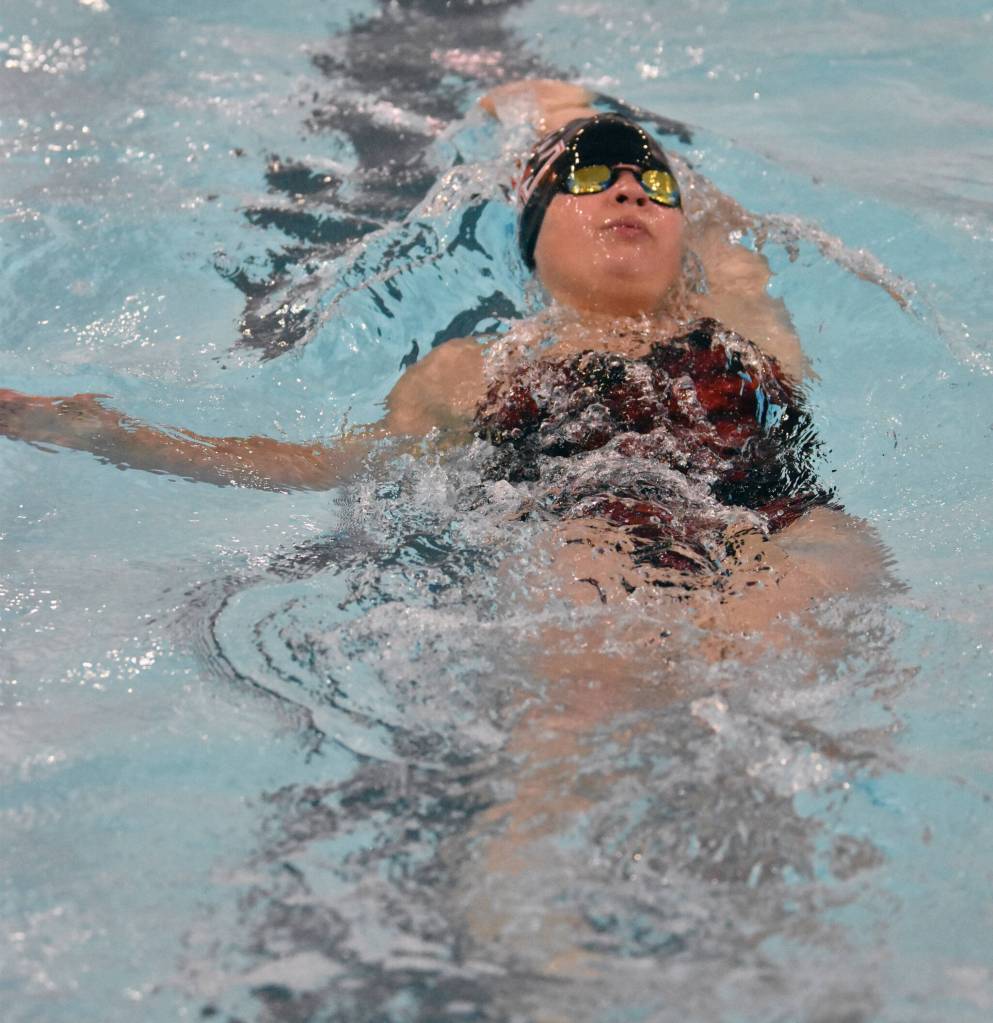Kenai Centrals Abigail Price competes in the 100-yard backstroke Friday, Aug. 29, 2025, at Kenai Central High School in Kenai, Alaska. (Photo by Jeff Helminiak/Peninsula Clarion)