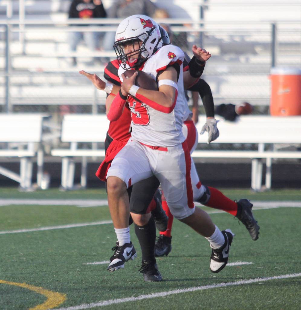 Kenai senior Kainoa Taylor breaks away for a gain during a 31-22 win over Houston on Friday, Sept. 5, at Houston High School in Houston, Alaska. (Photo by Jeremiah Bartz/Frontiersman)