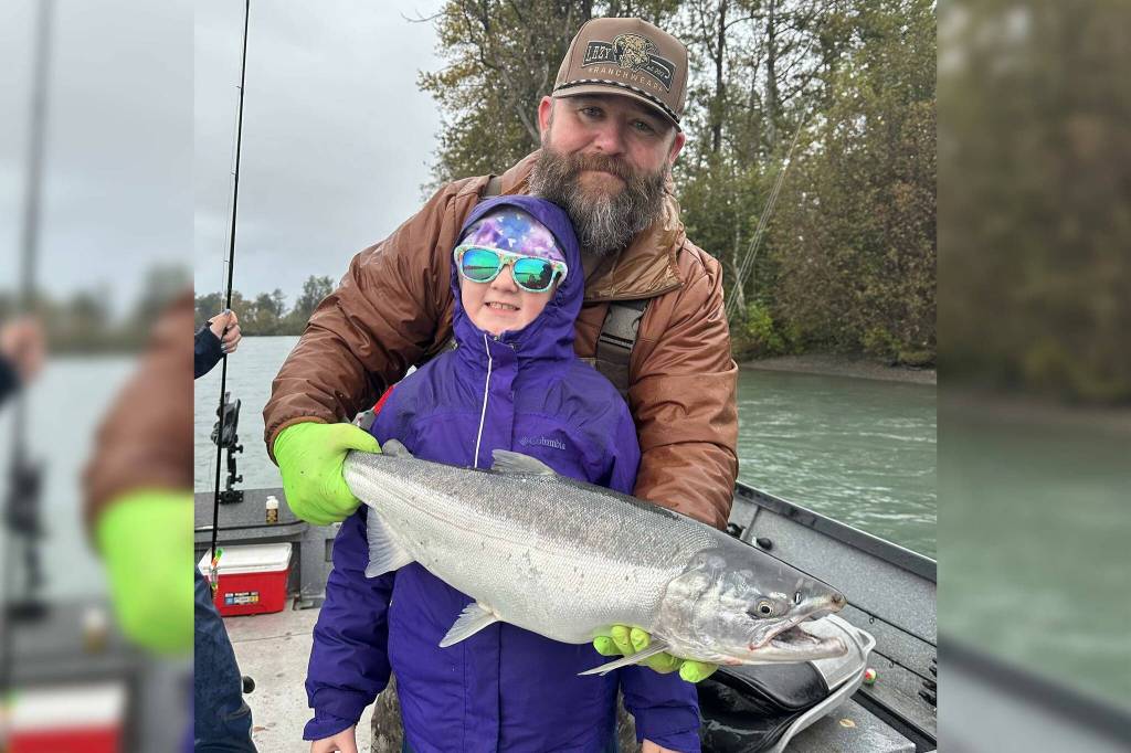 Nathaniel and Abigail Craig, stand with a coho during the Ninth Annual Kenai Silver Salmon Derby on the Kenai River near Kenai, Alaska. (Photo provided by Nathaniel Craig)