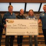 Tomi McMurray, second from right and winner of the Ninth Annual Kenai Silver Salmon Derby, stands with officials from the City of Kenai, Kenai Chamber of Commerce and Marathon Petroleum as shes awarded a novelty check for $5,000 at Kenai City Hall in Kenai, Alaska, on Wednesday, Sept. 17, 2025. (Jake Dye/Peninsula Clarion)