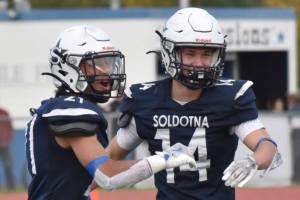 Soldotna's Dax Walden (14) celebrates his interception with Mason Bock against Wasilla on Friday, Sept. 19, 2025, at Justin Maile Field at Soldotna High School in Soldotna, Alaska. (Photo by Jeff Helminiak/Peninsula Clarion)
