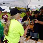 Susan Nabholz and Jeannette Pedginski recognize Gregory Eller, Saori Habuta and James Eller of Kaizen Ramen as the Most Local Food vendor during the Harvest Moon Local Food Festival at Soldotna Creek Park in Soldotna, Alaska, on Saturday, Sept. 20, 2025. (Jake Dye/Peninsula Clarion)