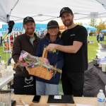 Gregory Eller, Saori Habuta and James Eller, of Kaizen Ramen, are recognized as the Most Local Food vendor during the Harvest Moon Local Food Festival at Soldotna Creek Park in Soldtona, Alaska, on Saturday, Sept. 20, 2025. (Jake Dye/Peninsula Clarion)