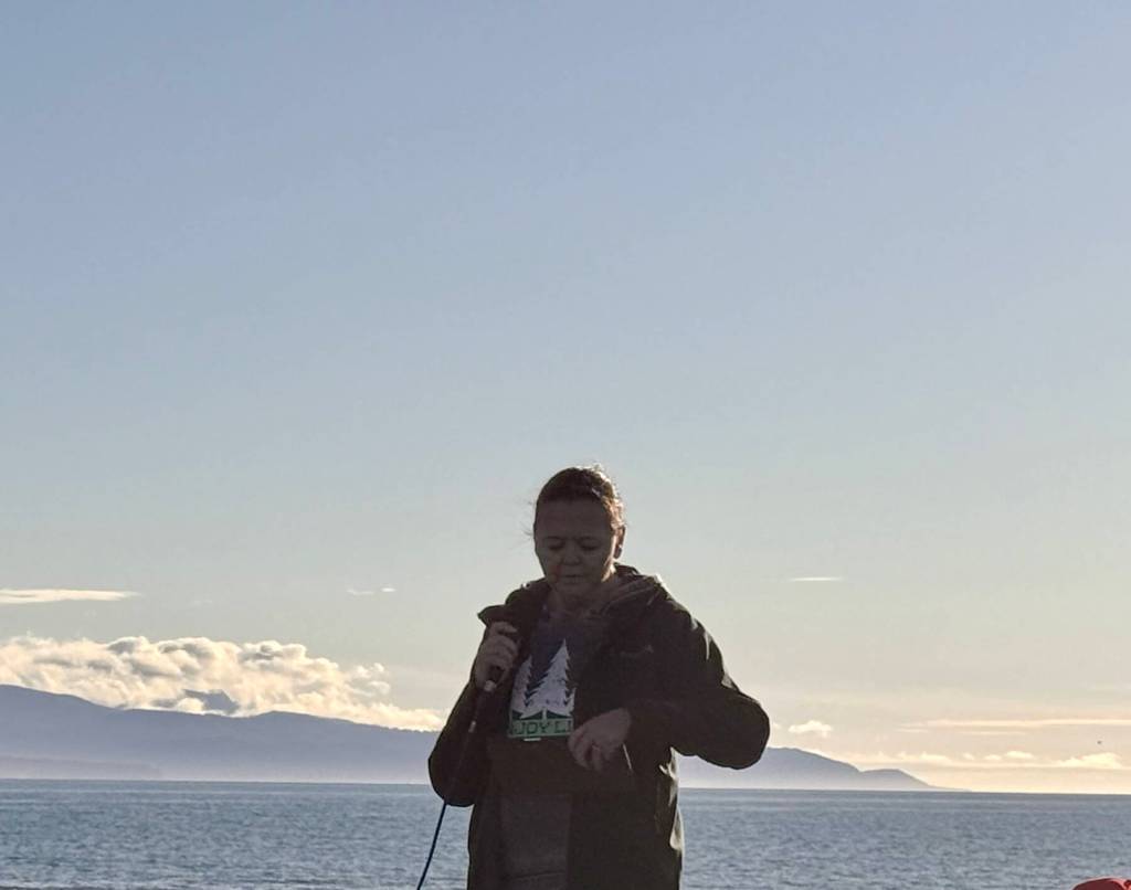 Cassie Lawver reads from a prepared script on Wednesday, Sept. 17, 2025, at a vigil for Charlie Kirk at Mariner Park on the Homer Spit in Homer, Alaska. (Chloe Pleznac/Homer News)