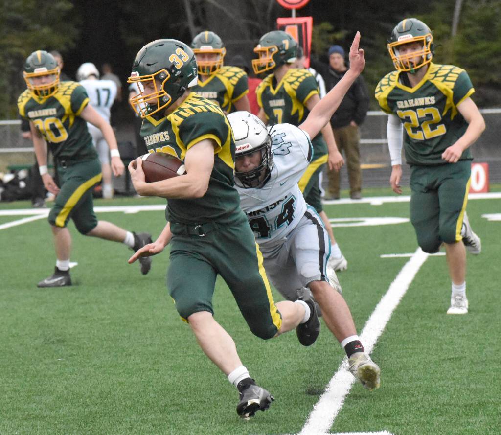 Sewards Camden Schrock fights for yards against Nikiskis Trigger McCaughey on Friday, Sept. 26, 2025, at Seward High School in Seward, Alaska. (Photo by Jeff Helminiak/Peninsula Clarion)