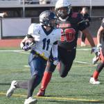 Homers Justus Grimes returns a punt against Kenai Centrals Aiden Nerby on Saturday, Sept. 27, 2025, at Ed Hollier Field at Kenai Central High School in Kenai, Alaska. (Photo by Jeff Helminiak/Peninsula Clarion)