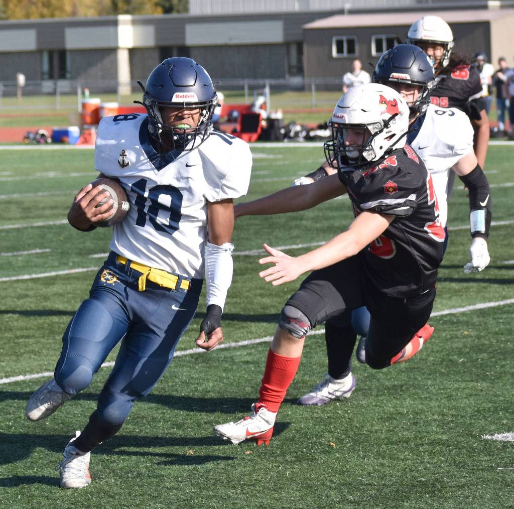 Homers Nik Macauly runs past Kenai Centrals Carson Cramer on Saturday, Sept. 27, 2025, at Ed Hollier Field at Kenai Central High School in Kenai, Alaska. (Photo by Jeff Helminiak/Peninsula Clarion)