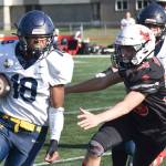 Homer's Nik Macauly runs past Kenai Central's Carson Cramer on Saturday, Sept. 27, 2025, at Ed Hollier Field at Kenai Central High School in Kenai, Alaska. (Photo by Jeff Helminiak/Peninsula Clarion)