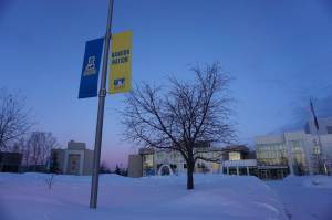 Sunset hues color the sky and the snow at the University of Alaska Fairbanks campus on Feb. 26, 2024. The University of Alaska system and the union representing nearly 1,100 faculty members and postdoctoral fellows are headed into federal mediation in January. (Yereth Rosen/Alaska Beacon)