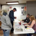 Anchor Point election workers help voters cast their ballots in the Kenai Peninsula Borough election on Tuesday, Oct. 7, 2025, at the Anchor Point Community and Senior Center in Anchor Point, Alaska. (Delcenia Cosman/Homer News)