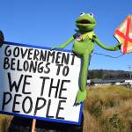 A sign carried by a protester during the No Kings demonstration on Saturday, Oct. 18, 2025, in Homer, Alaska, reads Government belongs to We the People.