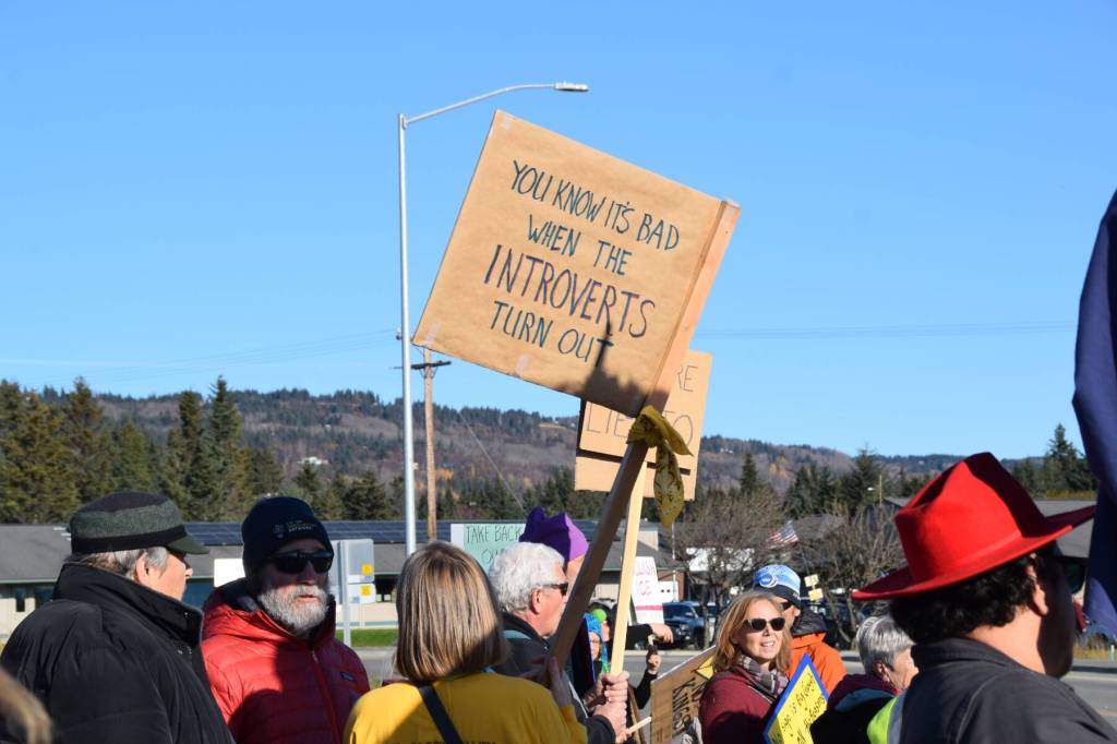 A protester holds a sign that reads You know its bad when the introverts turn out during the No Kings demonstration on Saturday, Oct. 18, 2025, in Homer, Alaska. (Delcenia Cosman/Homer News)