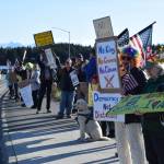 Protesters line up on the sidewalk along Sterling Highway, stretching out toward Ocean Drive, during the No Kings protest on Saturday, Oct. 18, 2025, in Homer, Alaska. (Delcenia Cosman/Homer News)