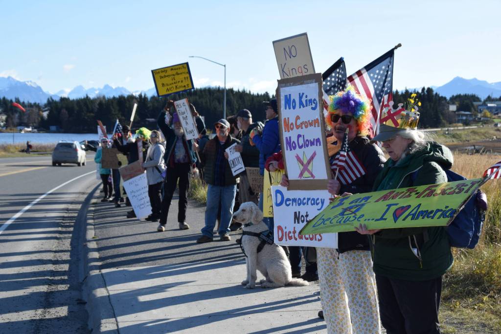 Protesters line up on the sidewalk along Sterling Highway, stretching out toward Ocean Drive, during the No Kings protest on Saturday, Oct. 18, 2025, in Homer, Alaska. (Delcenia Cosman/Homer News)