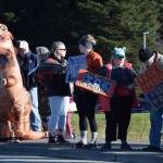 Protesters gather along Lake Street and hold signs during the No Kings demonstration on Saturday, Oct. 18, 2025, in Homer, Alaska. (Delcenia Cosman/Homer News)