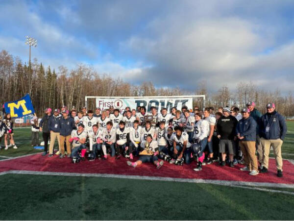 The Homer Mariners varsity football team gathers for a celebratory photo following their victory against Barrow in the Division III state championships game on Saturday, Oct. 18, 2025, in Wasilla, Alaska. Photo provided by Justin Zank