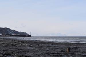 The waters of Cook Inlet lap against Nikishka Beach in Nikiski, Alaska, where several local fish sites are located, on Friday, March 24, 2023. (Jake Dye/Peninsula Clarion)
