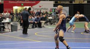 Senior Mason Bock exclaims after winning the state title during the ASAA Division I state championships in Anchorage, Alaska on Dec. 20, 2025. Bock beat No. 2 seed Isaiah Schultz of Colony High School in the final, securing his victory in the 135-pound title as the No. 4 seed. Bock said standing on the podium was the best moment of his life, telling the Clarion that since he had lost to Schultz once earlier in the season, he was “focused and determined to have a different outcome” during the final match. Photo courtesy of Andie Bock/Andie’s Alaskan Adventures Photography