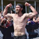 Photo by Jeff Helminiak/Peninsula Clarion James Carlberg, 34, of Seward finishes the mens race at the Mount Marathon Race on Friday, July 4, in Seward.