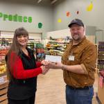 Mike Martin, manager of the Three Bears Alaska location in Soldotna, presents Johna Beech of the Kenai Peninsula Food Bank with a check for $15,432 on Jan. 14, 2026. Photo courtesy of Johna Beech