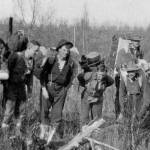 Here are some of the packers and guides used by a 1913 hunting party that included Edward Marshall Scull, who wrote a memoir about this trip. The memoir, Hunting in the Arctic and Alaska, included an uncropped version of this A.M. Collins photo. Ben Swesey is second from the right (directly in front of another man), posed here on the trail between Skilak Lake and the Killey River.