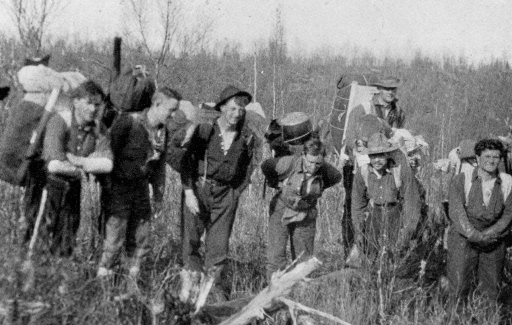 Here are some of the packers and guides used by a 1913 hunting party that included Edward Marshall Scull, who wrote a memoir about this trip. The memoir, Hunting in the Arctic and Alaska, included an uncropped version of this A.M. Collins photo. Ben Swesey is second from the right (directly in front of another man), posed here on the trail between Skilak Lake and the Killey River.