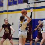 Sophomore Abby Ostrom seeks to pass the ball to senior Keagan Niebuhr during the varsity game against Grace Christian on Saturday, Feb. 7, 2026, during the annual Winter Carnival basketball tournament in the Alice Witte Gymnasium at Homer High School in Homer, Alaska. (Delcenia Cosman/Homer News)