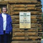 Photo courtesy of Michael Lee
In Soldotna in 1992, Maxine Lee stands in front of her old homestead cabin, which became Soldotnas first post office 1949. Lee became the communitys first postmaster.