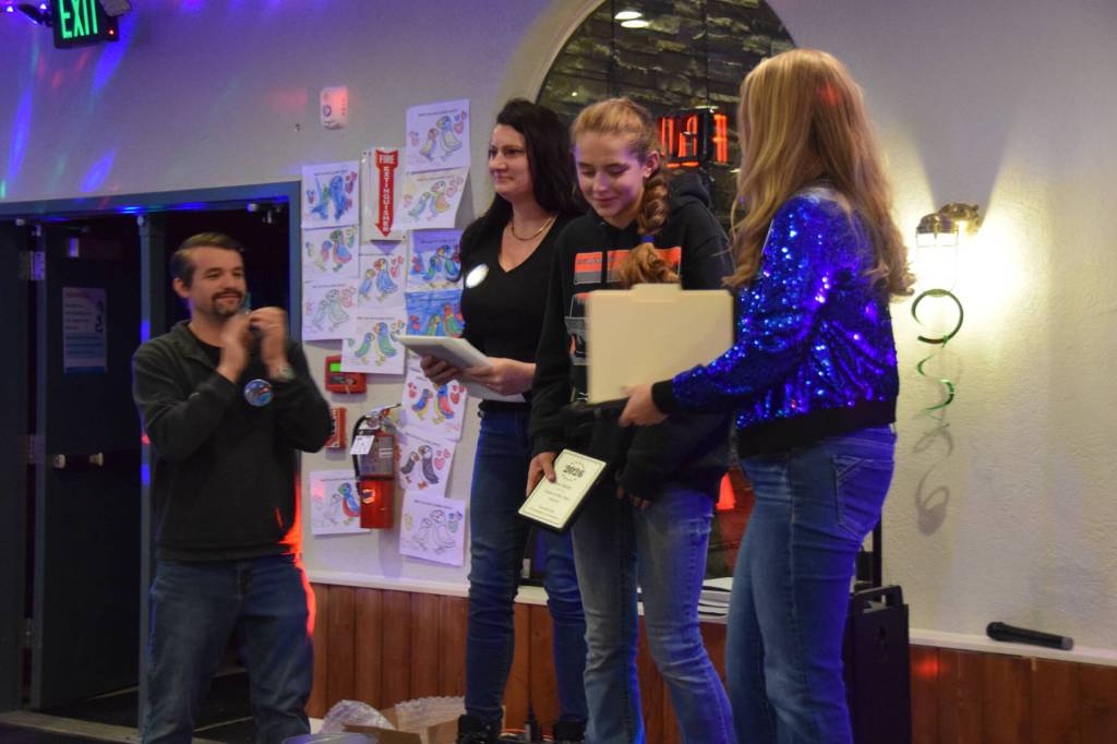 Rox Shafer (center) receives the Youth of the Year award during the Community Awards presentation on Saturday, Feb. 28<ins>, 2026</ins> at the Angry Salmon in Anchor Point<ins>, Alaska</ins>. (Delcenia Cosman/Homer News)
