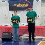 Elora Couturier (left) and Andrew Bearden (right) hold up their trophies at the 2nd annual Alaska Centershot State Tournament, held March 13-14, 2026, in Palmer, Alaska. Couturier won first place overall in the girls division and Bearden won first place overall in the boys division. Photo provided by Rick Johnson