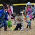 Kids in grades 2-3 snatch up Easter eggs on the lower baseball field at Karen Hornaday Park during the community egg hunt hosted by Church on the Rock Homer on Saturday, April 4, 2026, in Homer, Alaska. (Delcenia Cosman/Homer News)