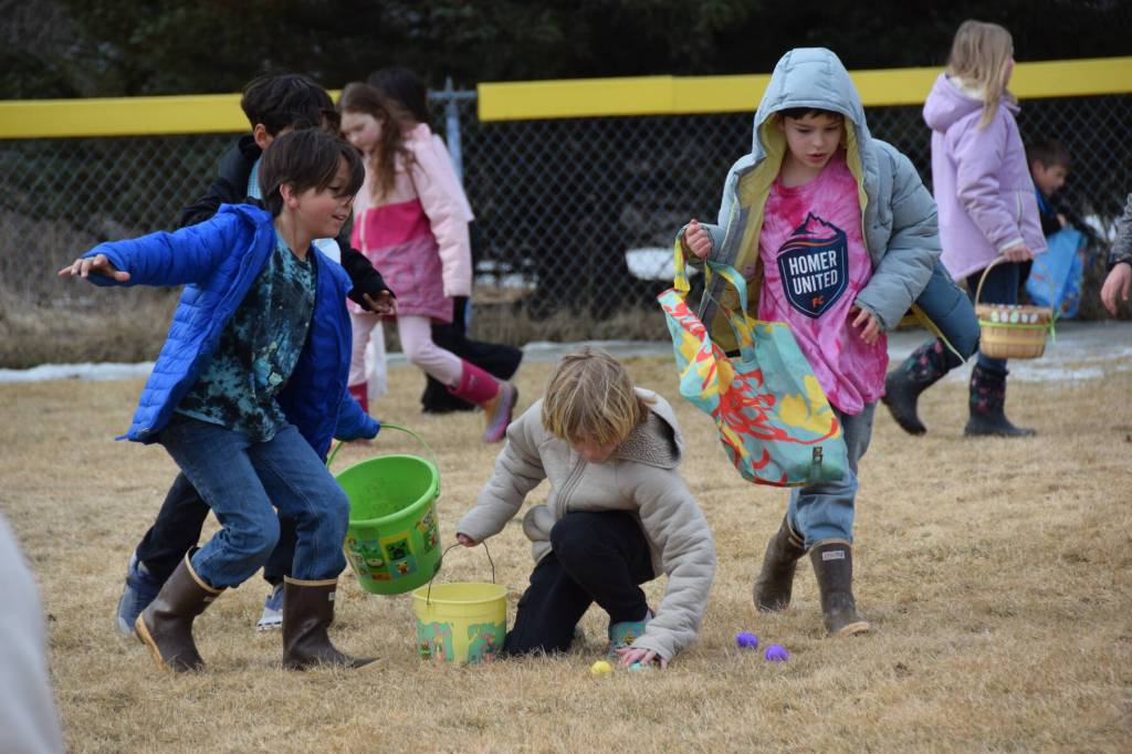 Kids in grades 2-3 snatch up Easter eggs on the lower baseball field at Karen Hornaday Park during the community egg hunt hosted by Church on the Rock Homer on Saturday, April 4, 2026, in Homer, Alaska. (Delcenia Cosman/Homer News)