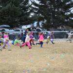 Kindergarteners and first-graders sprint across a field at Karen Hornaday Park at the start of the Easter egg hunt for their age group on Saturday, April 4, 2026, in Homer, Alaska. (Delcenia Cosman/Homer News)