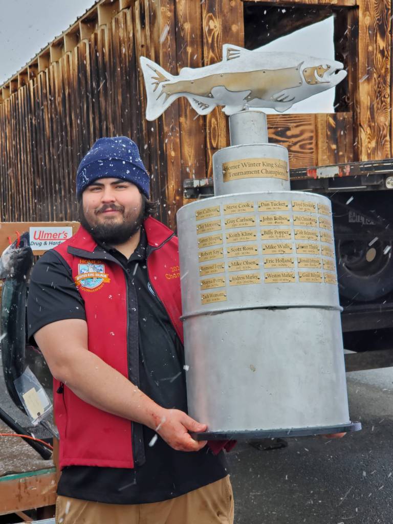 Delcenia Cosman / Homer News
Tournament winner Michael Ardenia holds up the championship trophy during the 32nd annual Homer Winter King Tournament on Saturday, April 4.