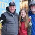 Delcenia Cosman / Homer News
Aaron Challans from Soldotna poses with his daughter and 2025 Top Youth Angler winner Madelyn Challans (center) and Homer Chamber of Commerce executive director Brad Anderson (right) after winning 10th place during the 32nd annual Homer Winter King Tournament on Saturday, April 4.