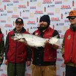 Michael Ardenia (center right), winner of the 32nd annual winter king tournament, holds up his winning fish alongside past tournament and youth champions during the 32nd annual Homer Winter King Tournament on Saturday, April 4, 2026, in Homer, Alaska. (Delcenia Cosman/Homer News)