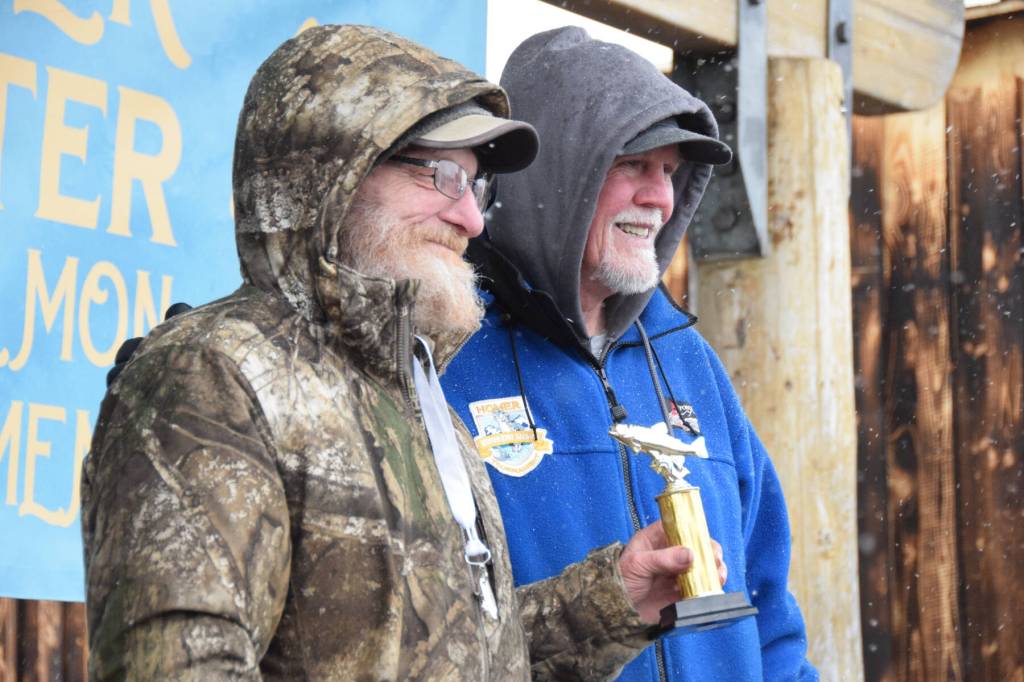 Stephen M. Krause (left) from Soldotna holds up his fourth place trophy during the 32nd annual Homer Winter King Tournament on Saturday, April 4, 2026, in Homer, Alaska. (Delcenia Cosman/Homer News)