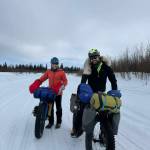 Ned Rozell, left, and Forest Wagner of Fairbanks push their bikes on the Unalakleet River just outside the village of the same name. (Photo by Warren Katchatag)