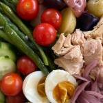 Tressa Dale/Peninsula Clarion There are endless variations of this dish, but standard ingredients include green beans, boiled eggs, potatoes, olives, tomatoes, and high-quality canned fish like tuna or sardines, all on a bed of greens and dressed with a sauce of lemon and oil with herbs, capers, mustard, and anchovies.