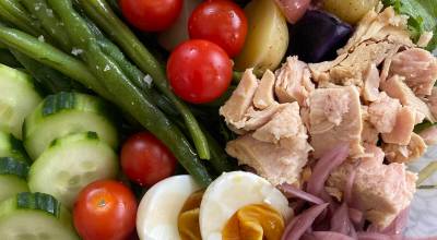 Tressa Dale/Peninsula Clarion There are endless variations of this dish, but standard ingredients include green beans, boiled eggs, potatoes, olives, tomatoes, and high-quality canned fish like tuna or sardines, all on a bed of greens and dressed with a sauce of lemon and oil with herbs, capers, mustard, and anchovies.