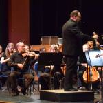 Homer High School choir director Kyle Schneider conducts the Mozart "Requiem" on the Homer High School Mariner Theatre stage on Friday, May 1, 2026, in Homer, Alaska. (Delcenia Cosman)