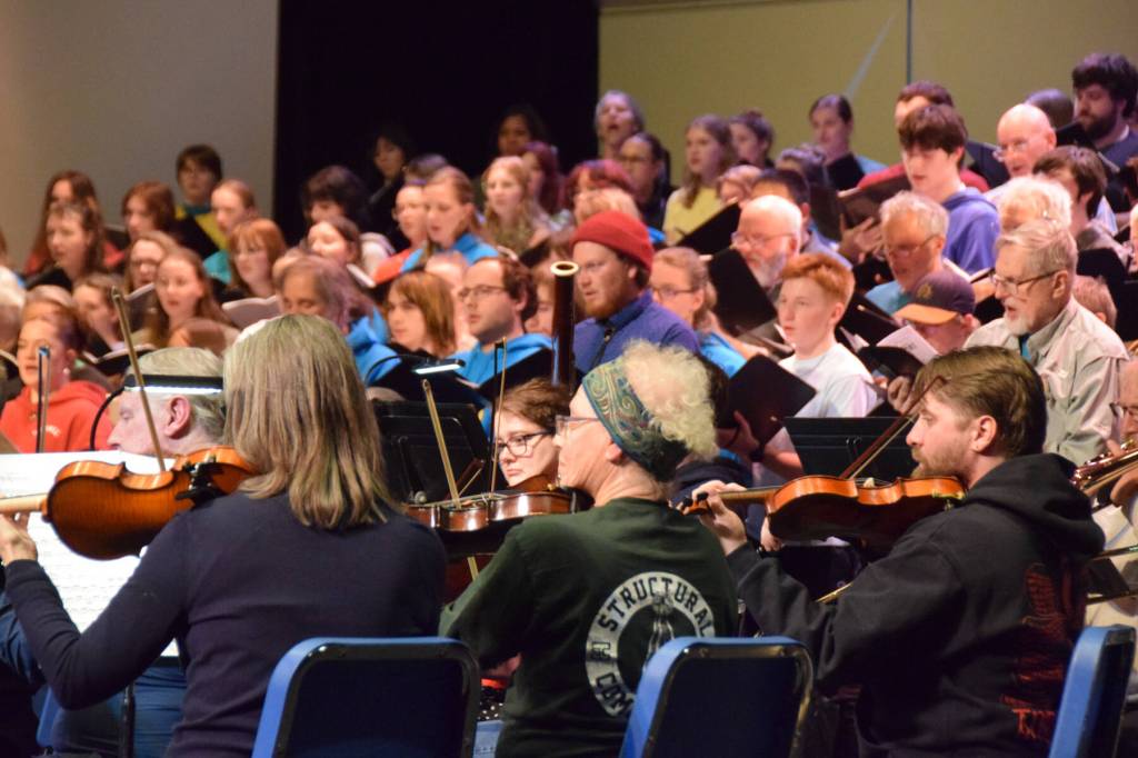 Members of the community orchestra rehearse the Mozart "Requiem" alongside the vocal ensemble on Thursday, April 30, 2026, on the Homer High School Mariner Theatre stage in Homer, Alaska. (Delcenia Cosman/Homer News)