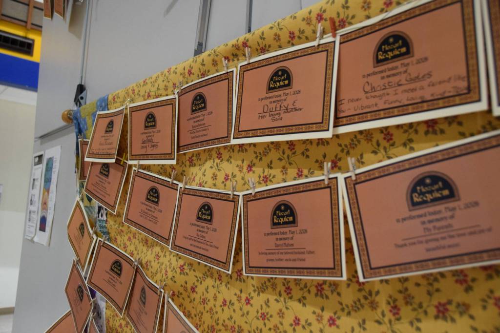 Memorial certificates are displayed on a memory wall in the Homer High School Commons as part of the Mozart "Requiem" performance on Friday, May 1, 2026, in Homer, Alaska. (Delcenia Cosman/Homer News)