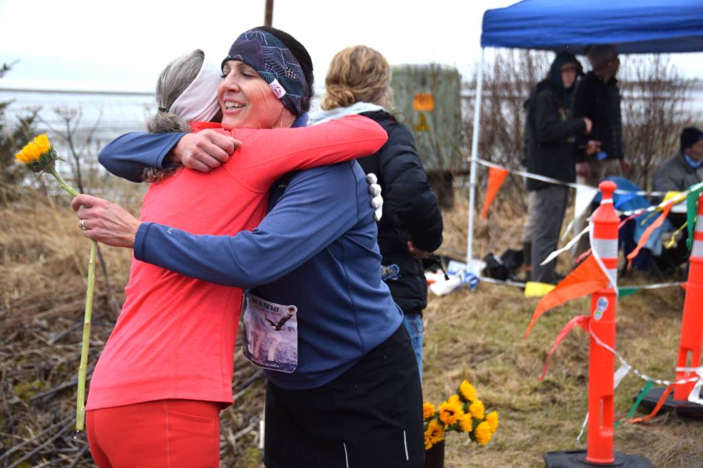 Runners give each other a congratulatory hug at the finish line of the annual Migration Run held Sunday, May 10<ins>, 2026,</ins> on the Homer Spit Trail<ins> in Homer, Alaska</ins>. (Delcenia Cosman/Homer News)