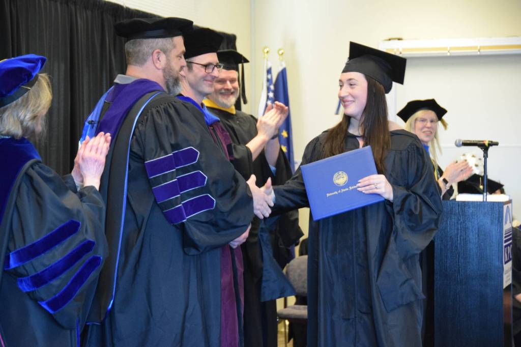 University of Alaska Fairbanks graduate Emily Ault (right) shakes hands with UA Regent Joe Crum during a commencement ceremony held Wednesday, May 6<ins>, 2026,</ins> at Kachemak Bay Campus<ins> in Homer, Alaska</ins>. (Delcenia Cosman/Homer News)