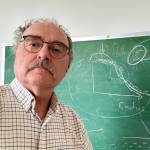 Rod Boyce stands in front of David Newmans chalkboard sketch made during a discussion of magnetic confinement nuclear fusion. (Photo by Rod Boyce)