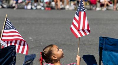 Olivia Vanni file photo 
Campbell M., 4, looks up at her American flag during the Fourth of July Parade.