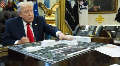 Doug Mills/The New York Times 
FILE  President Donald Trump with a model of his proposed ballroom, in the Oval Office of the White House in Washington, Dec. 12, 2025.
